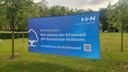 Ein Banner kündigt die Einweihung des Klimawaldes an.